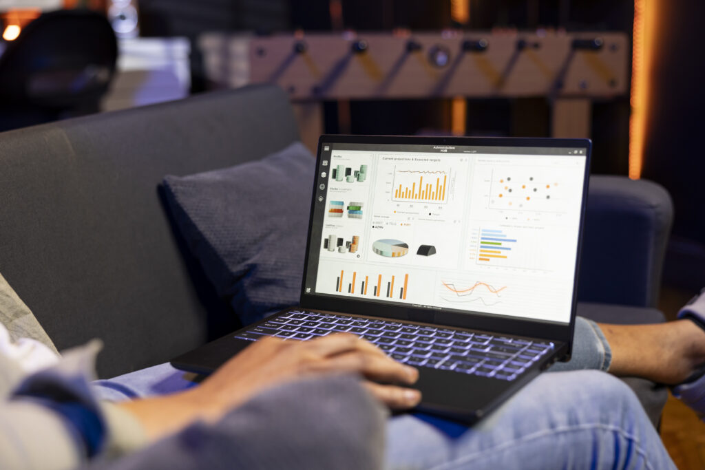 Person using a laptop displaying analytics dashboards and charts, representing marketing measurement, attribution, and performance reporting.
