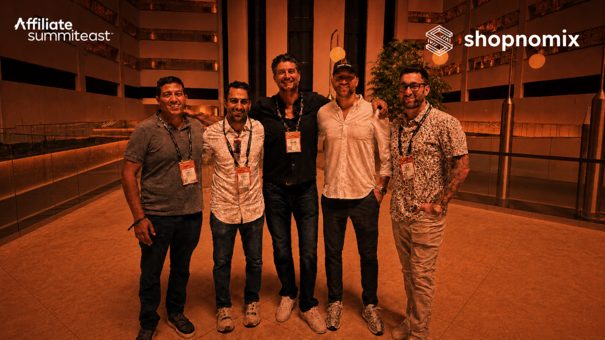 Five Shopnomix team members standing in the Affiliate Summit East convention lobby